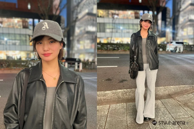 夜の街角に立つ若い女性のストリートファッション