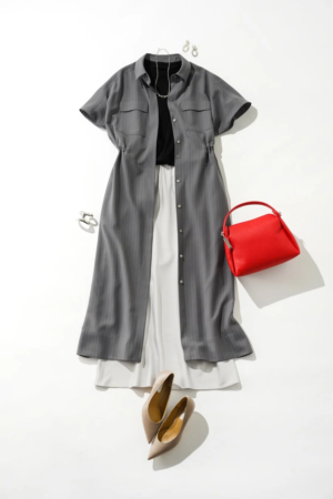 グレーのストライプ柄シャツワンピースを羽織り、白のパンツと黒のインナーを合わせた大人カジュアルなコーディネート