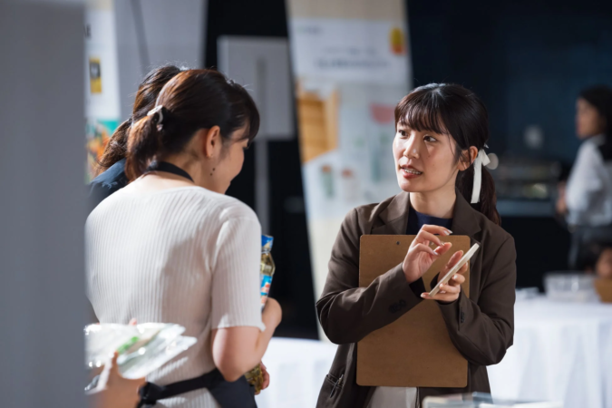 イベント会場で会話する女性