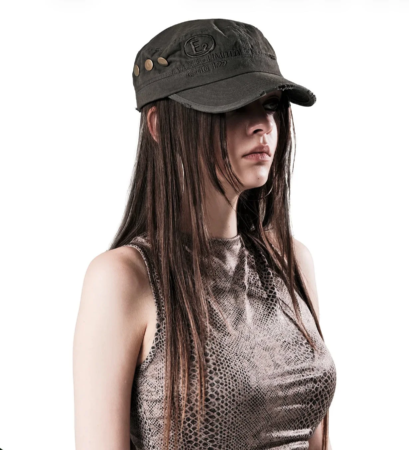 ミリタリーキャップとスネーク柄のトップスを着用した女性のポートレート